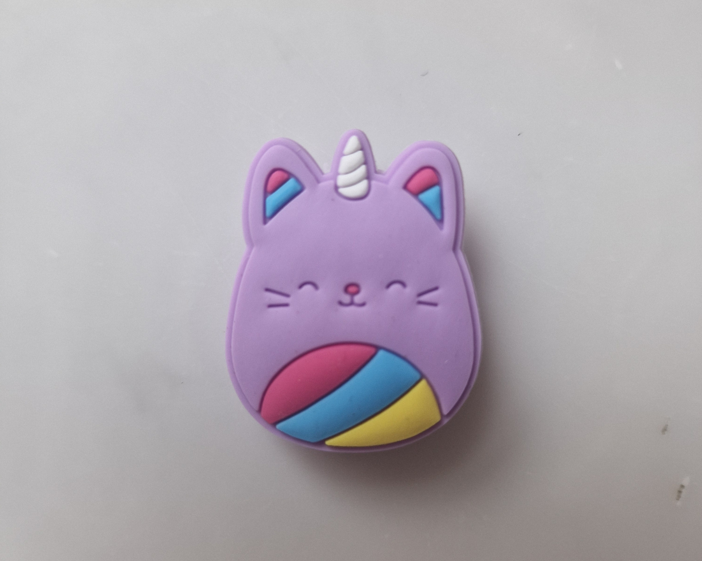 a purple cat with a unicorn horn on it's head