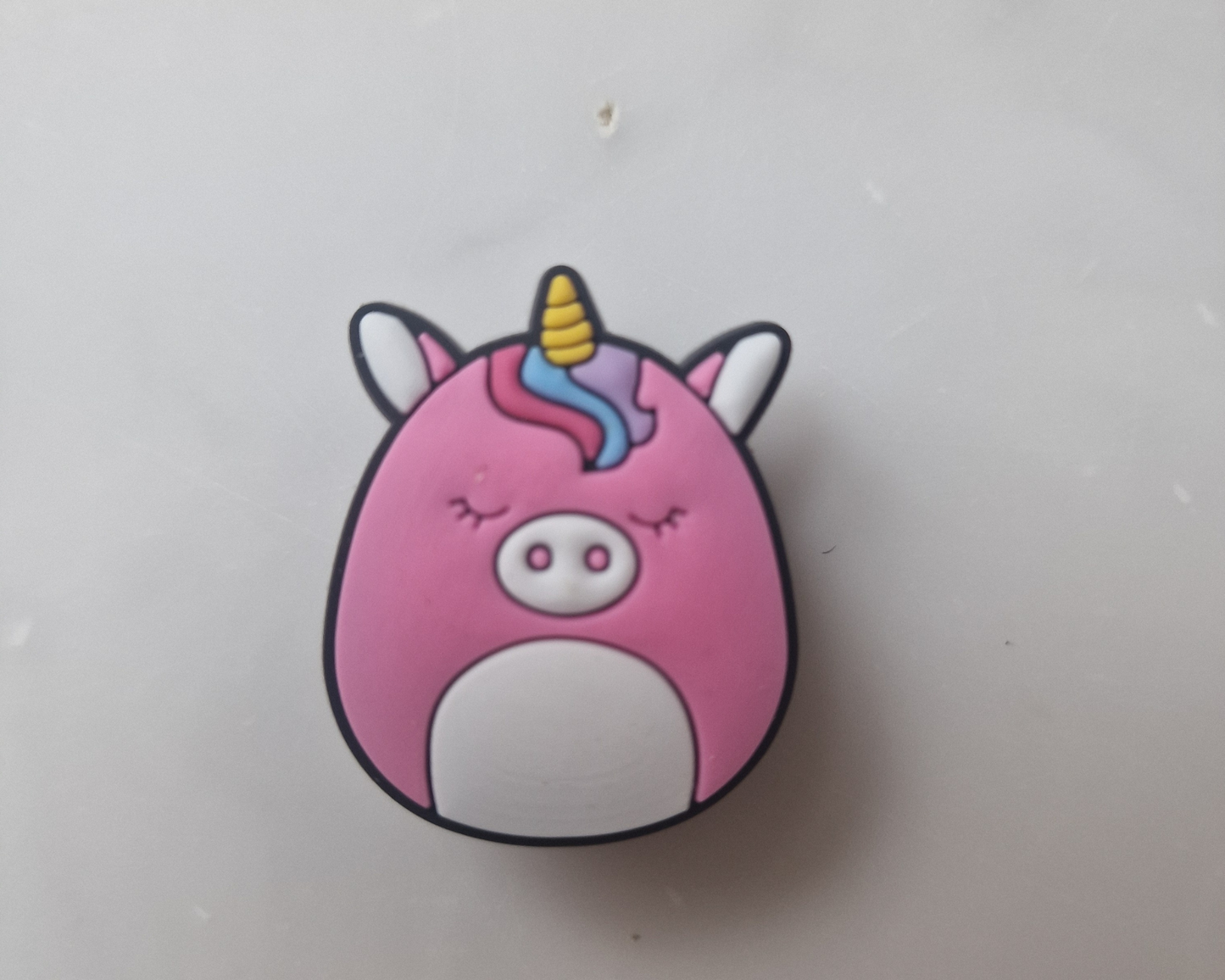 a pink pig with a unicorn horn on it's head