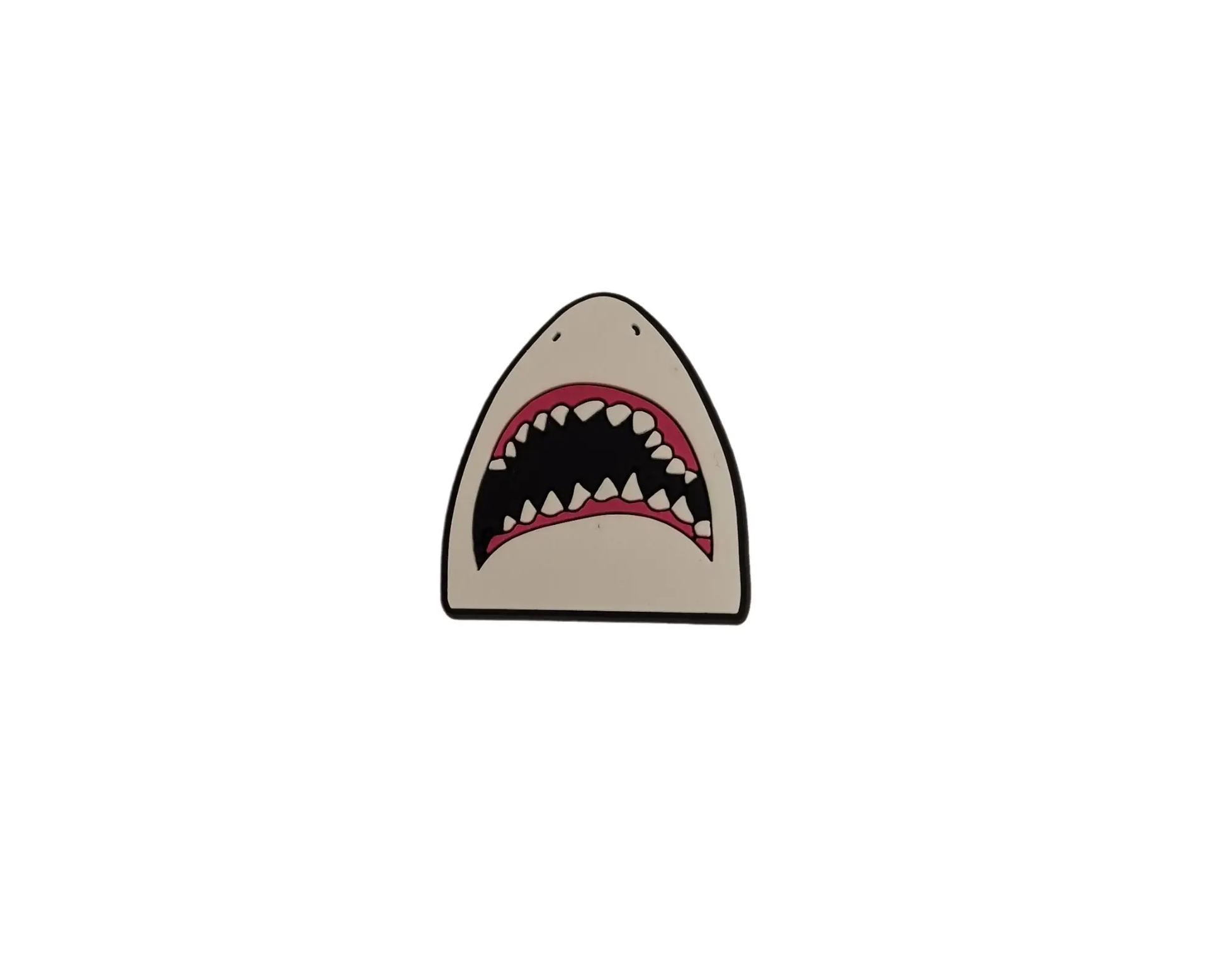 a shark's teeth charm on a white background