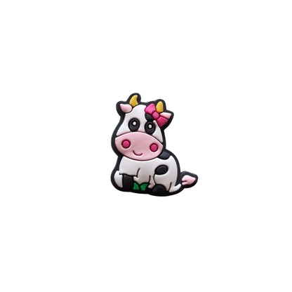 a cow with a pink bow sitting down