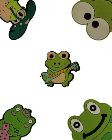 a group of frog stickers sitting on top of a white surface