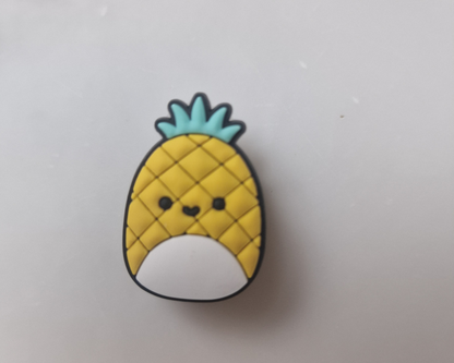 a pin with a pineapple face on it