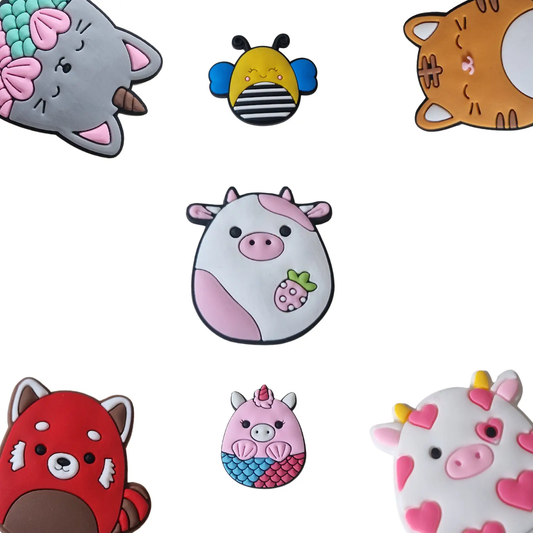 a group of different animal shaped charms on a white surface